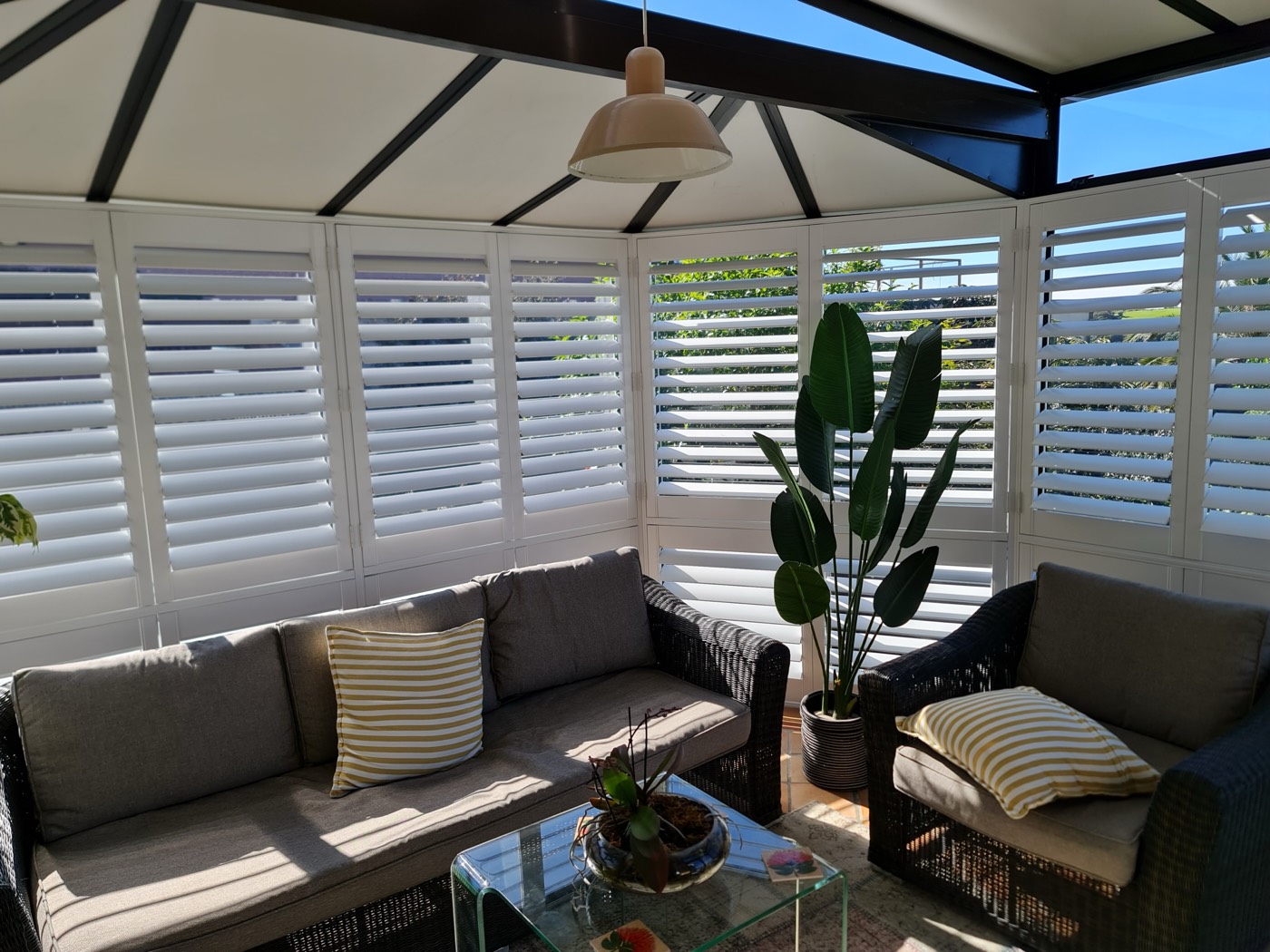Shutters in a sunroom with views