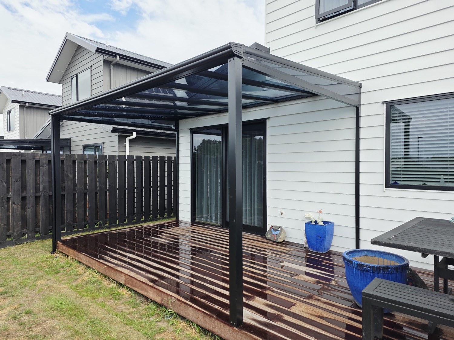 Glass-roof pergola over a timber deck