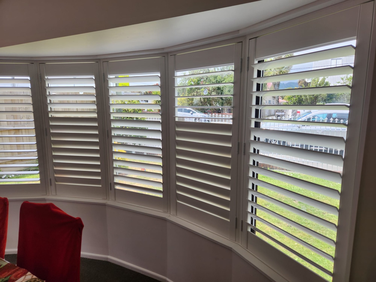 Curved bay window fitted with white shutters