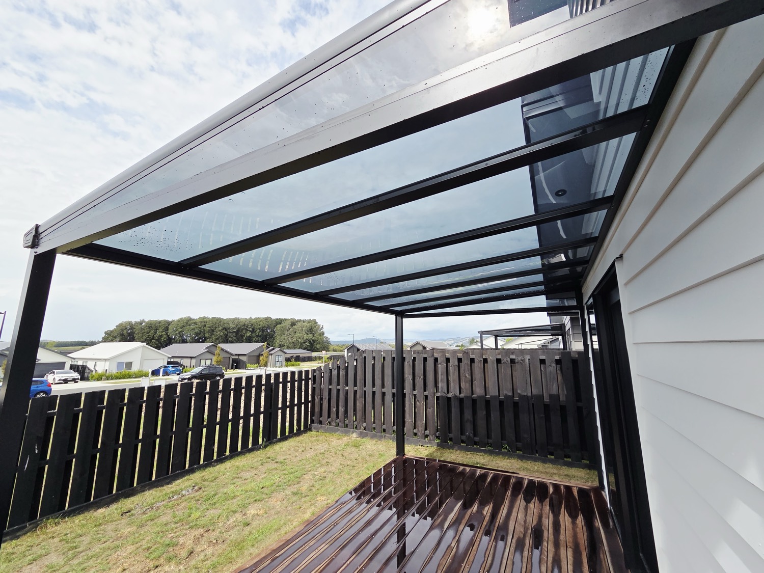 Modern glass-roof pergola over an outdoor deck